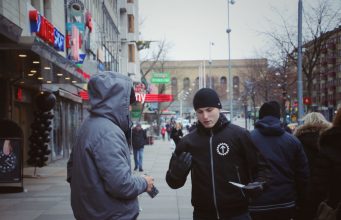 A Nordic Resistance Movement activist talks with a member of the public in Gothenburg