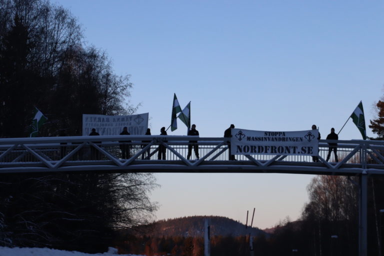 Nest 5 Nordic Resistance Movement activists hold banners on a bridge in Borlänge, Sweden