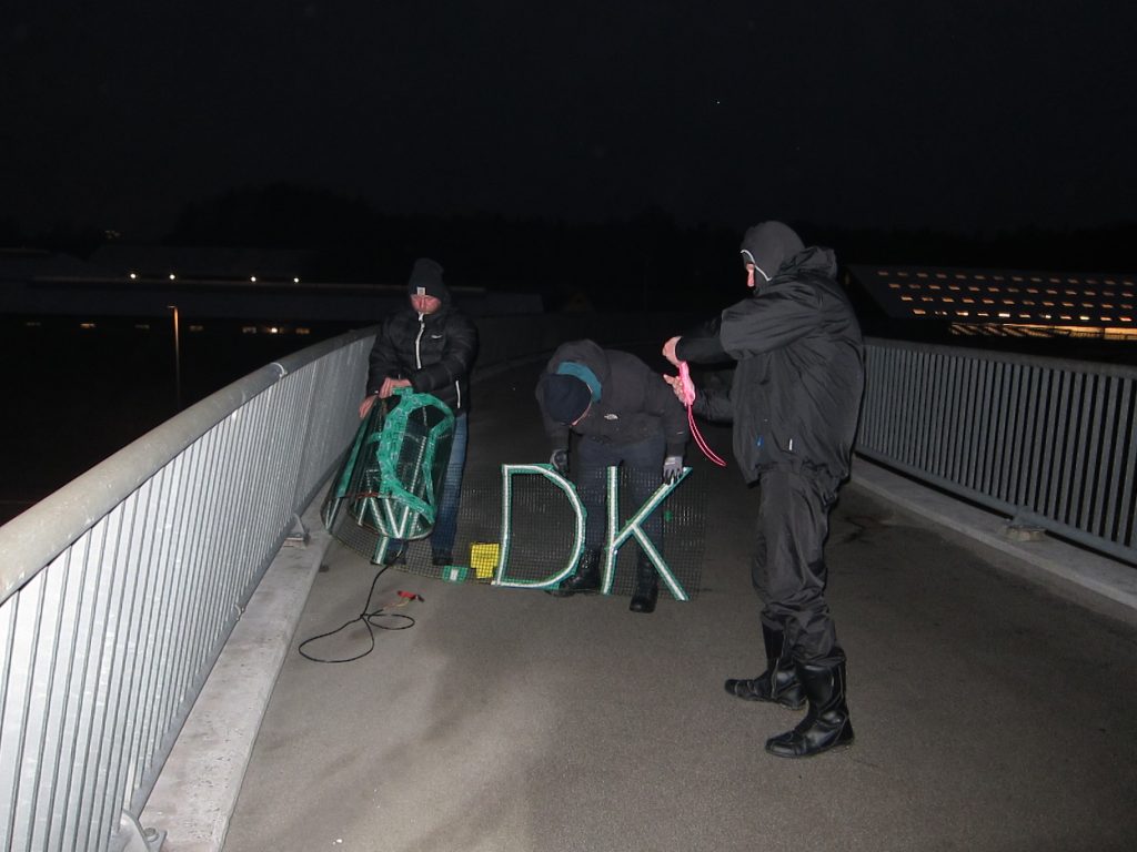 Danish Nordic Resistance Movement activists advertise the branch’s website with a glowing LED banner in Glostrup, Copenhagen