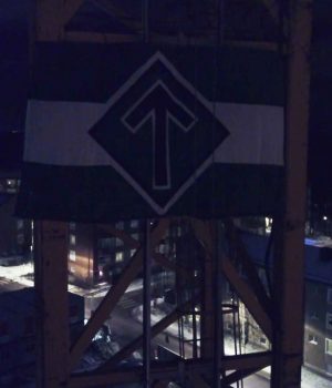 The Nordic Resistance Movement flag attached to a crane in Kärrtorp, Sweden