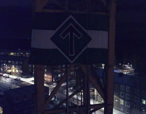 The Nordic Resistance Movement flag attached to a crane in Kärrtorp, Sweden