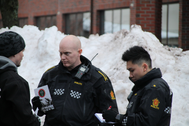 Nordic Resistance Movement members talk with police in Horten, Norway