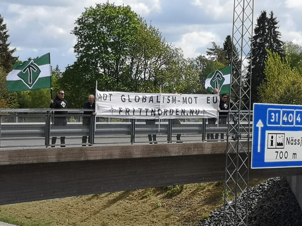 Nordic Resistance Movement activists hold a banner above a road near Jönköping