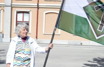 Vera Oredsson holding Nordic Resistance Movement flag