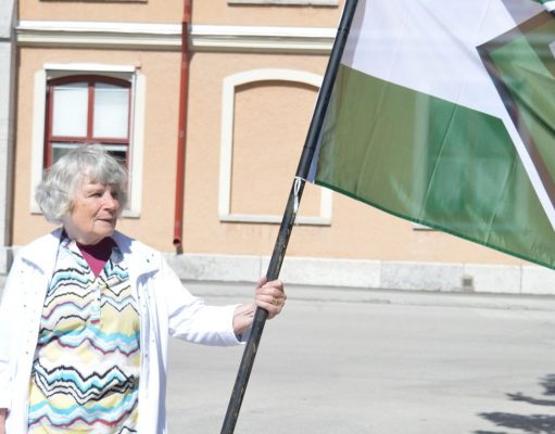 Vera Oredsson holding Nordic Resistance Movement flag