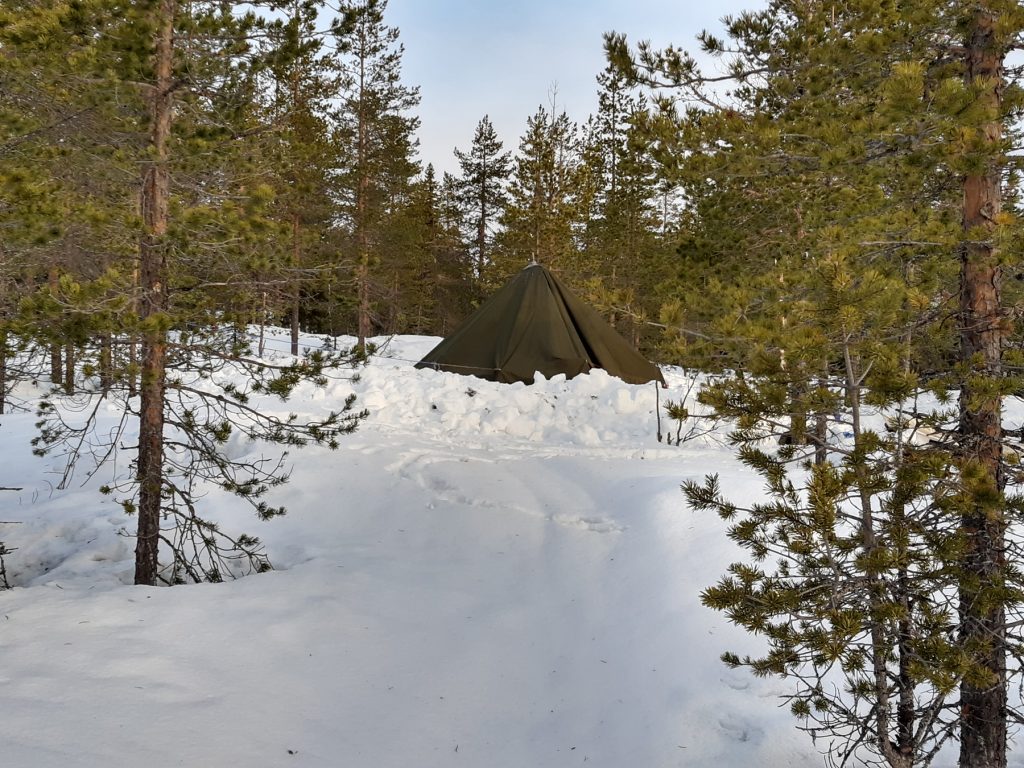 A tent in the snowy forest in northern Sweden