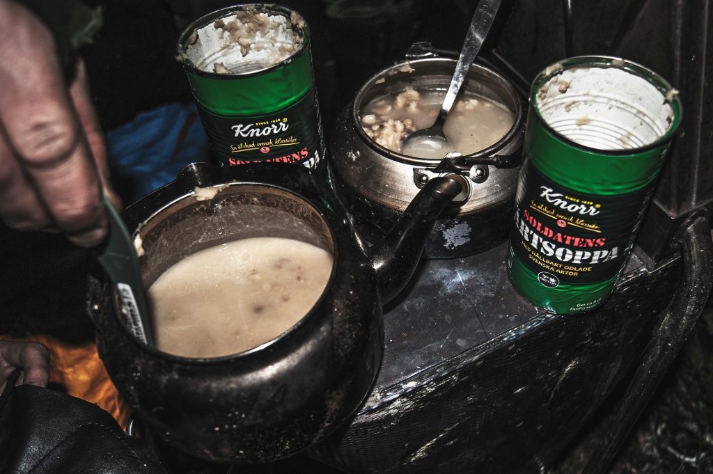 Cans of pea soup at a campsite