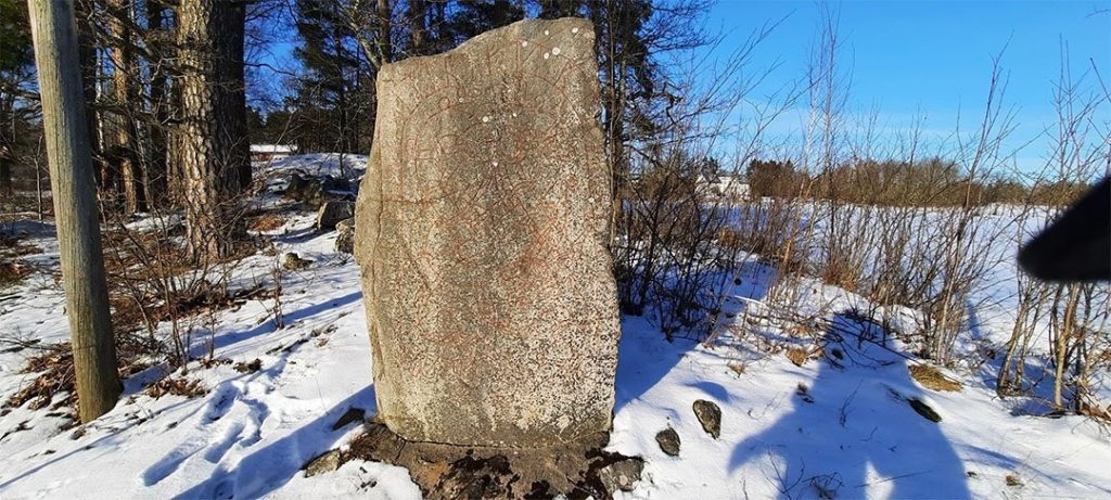 A runestone in Sweden surrounded by snow