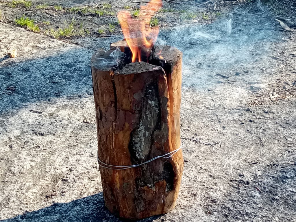 A "Swedish candle" at a campsite