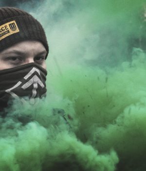 Nordic Resistance Movement activist amidst green smoke