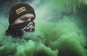 Nordic Resistance Movement activist amidst green smoke