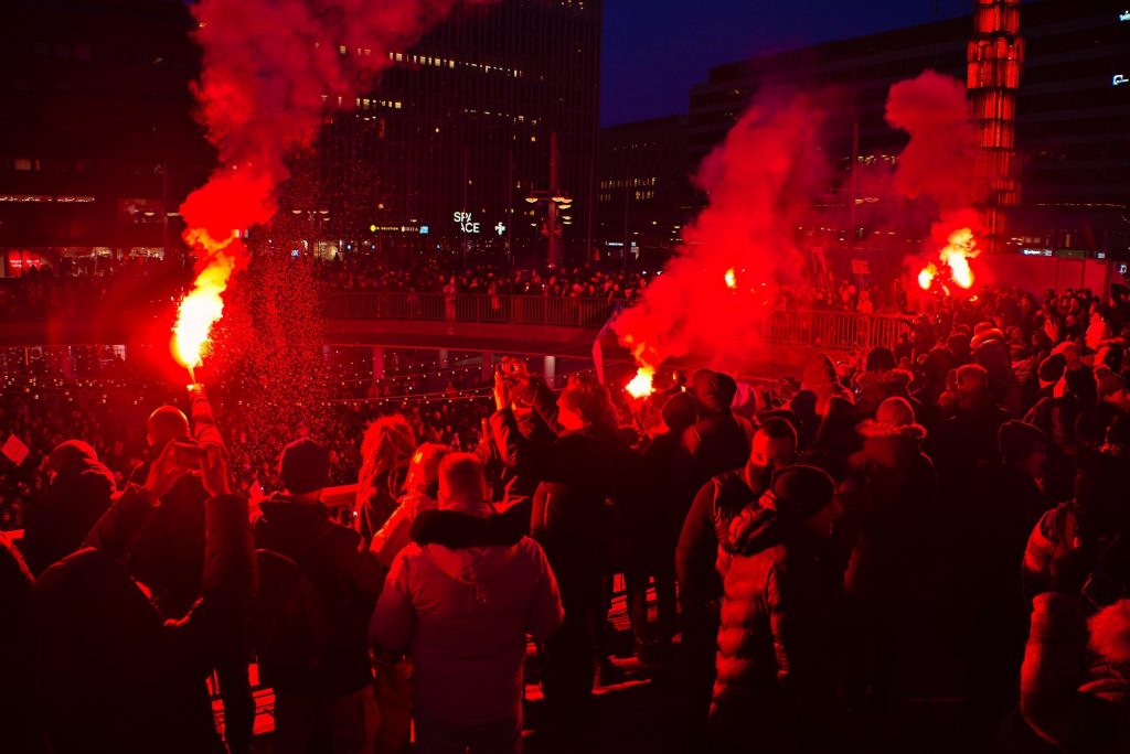 Nordic Resistance Movement activists with flares at anti-vaccine passport demonstration, Stockholm