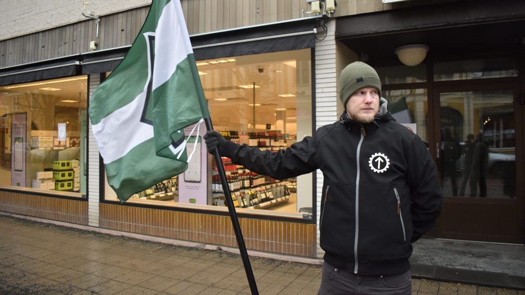 NRM activist with flag in Eksjö, Sweden