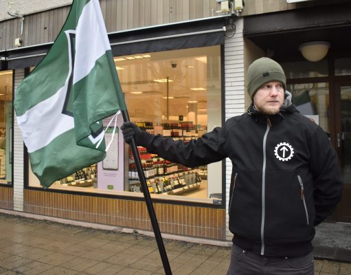 NRM activist with flag in Eksjö, Sweden