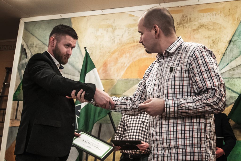 Simon Lindberg awards a diploma at the Nordic Resistance Movement 25th anniversary celebration