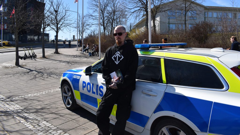 NRM activist with police car at motor show in Elmia, Jönköping, Sweden