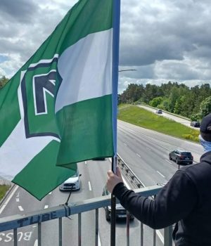 Nordic Resistance Movement activist at banner action on Stockholm bridge