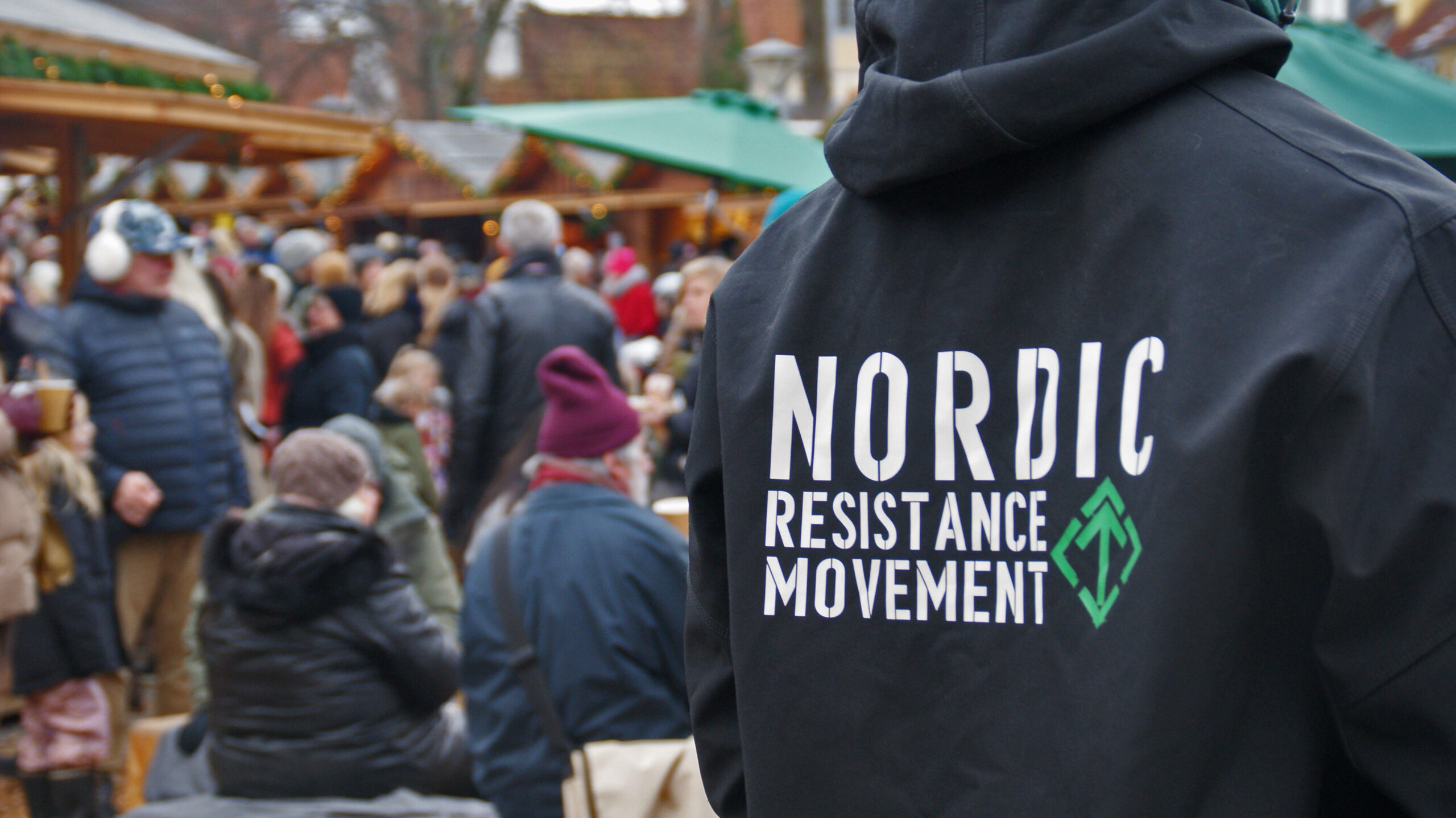 Nordic Resistance Movement activist with jacket at Odense Christmas Market, Denmark