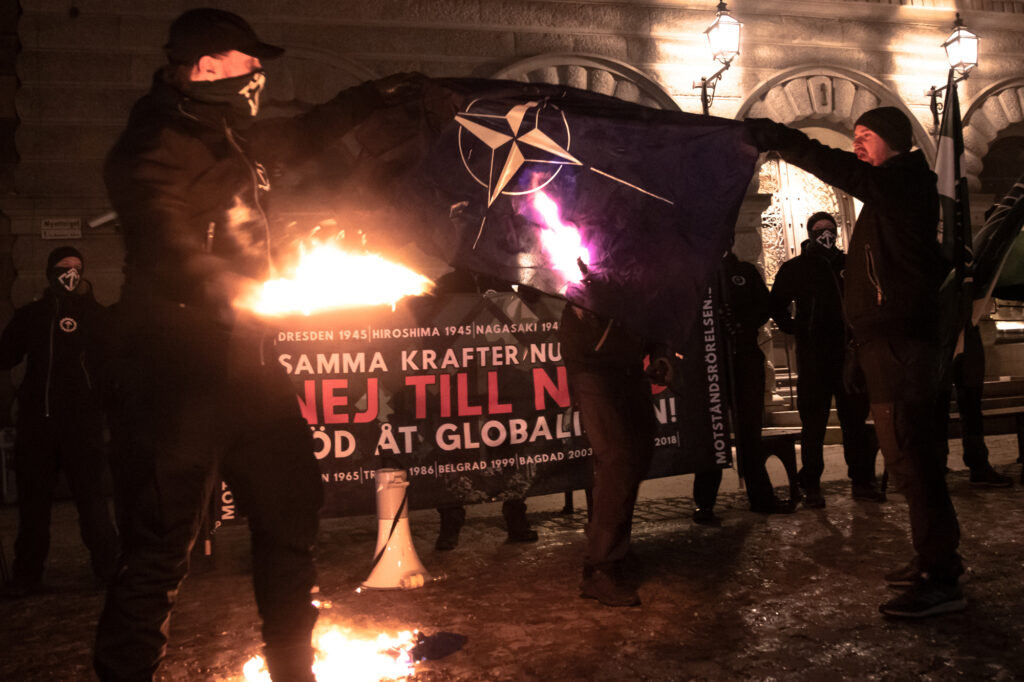 Nordic Resistance Movement Stockholm Dresden Nato protest, Simon Lindberg speech burning Nato flag