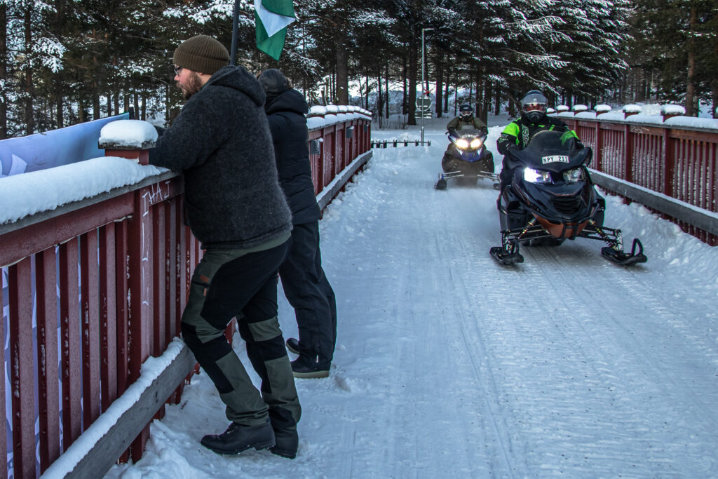 Nordic Resistance Movement banner action, Luleå, Sweden, passing snowmobilers
