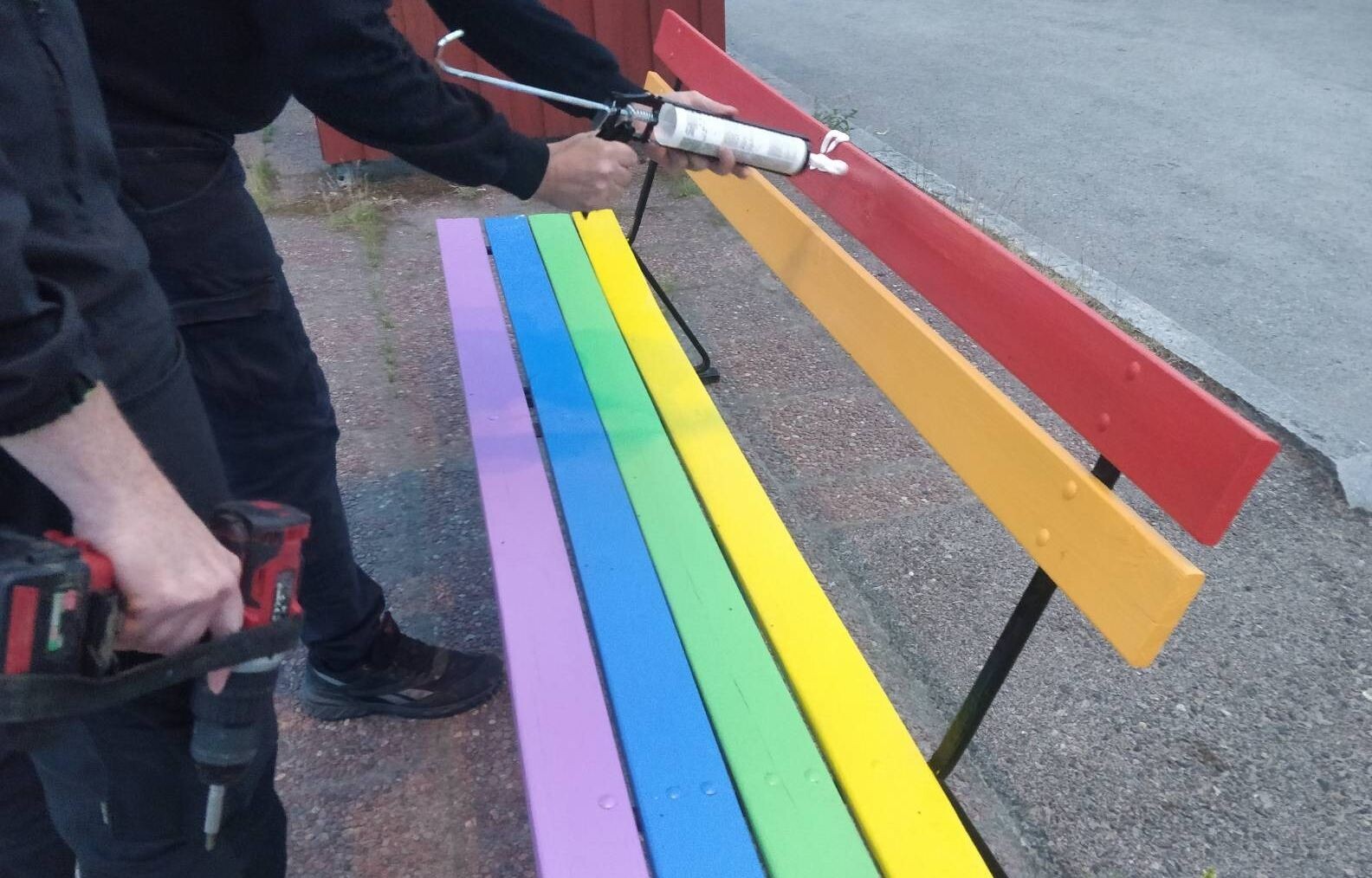 LGBTQP bench affixed with warning sign, Ludvika, Sweden