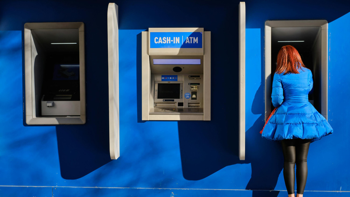 A person using an ATM.